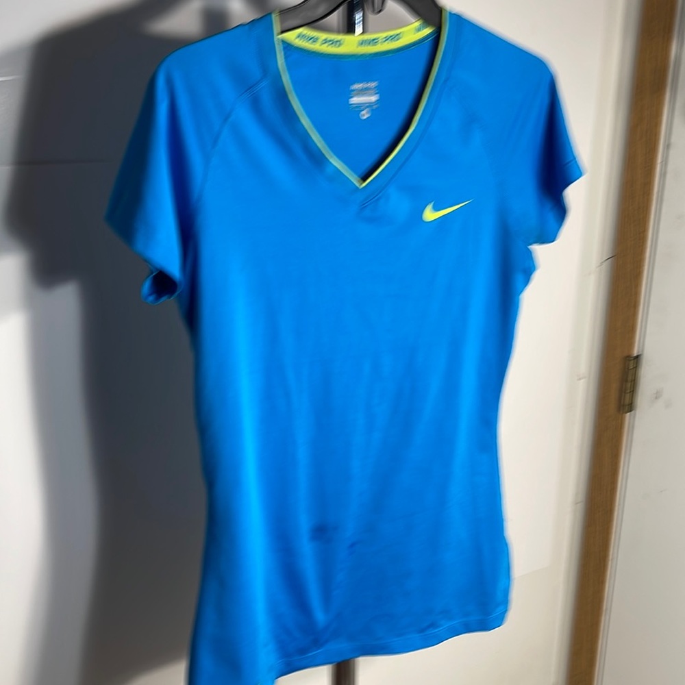 Two Nike pro shirts size medium one is blue and one is lime green